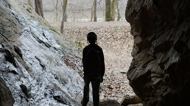 Arthur standing between 2 rocks gazing