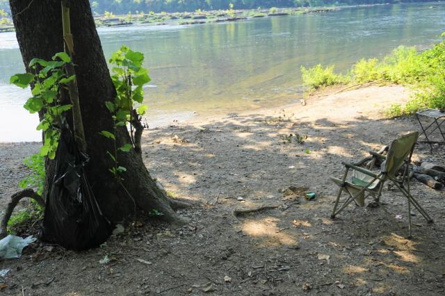 Trash and a fishing chair left on the bank of the Potomac