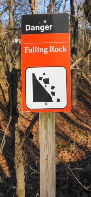 Orange, black and white warning sign.
